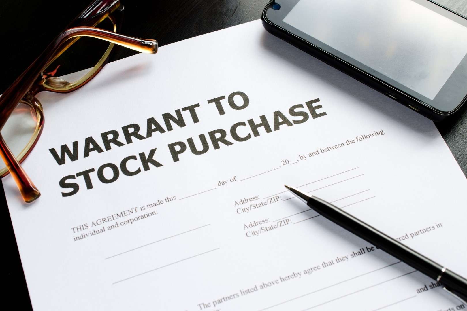 Business owner reviewing stock purchase agreement with attorney in Los Angeles