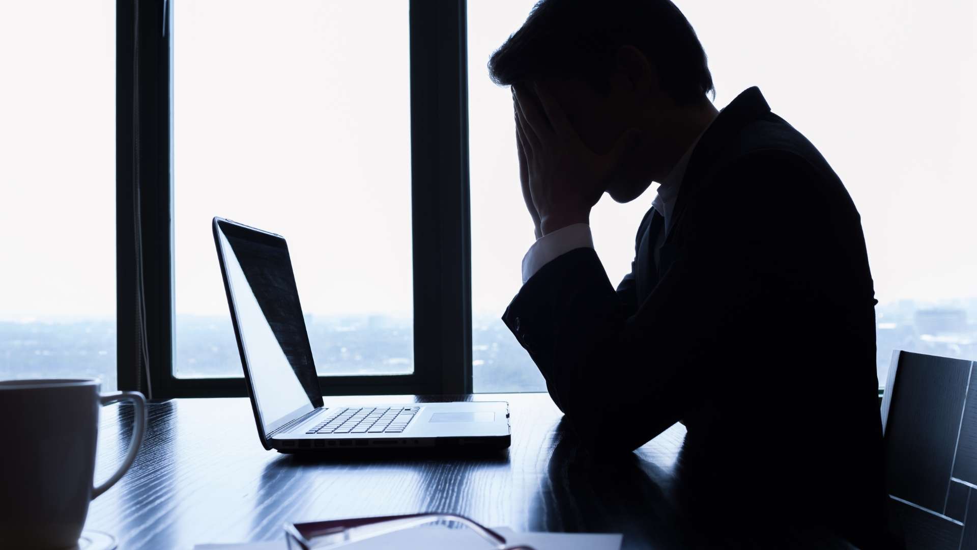 The image depicts a faceless business professional in a sleek, modern Los Angeles office, dressed in a white shirt and red tie. The individual sits at a polished desk, surrounded by creative and legal tools