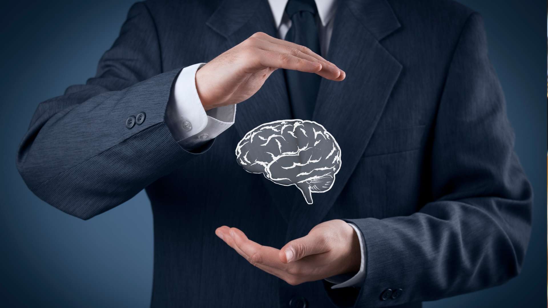 Businessman in suit protecting a brain illustration, symbolizing intellectual property protection