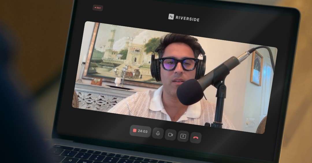 A man wearing headphones and glasses, speaking into a large professional microphone during a Riverside.fm video recording. He is one of the attorneys featured in the podcast.