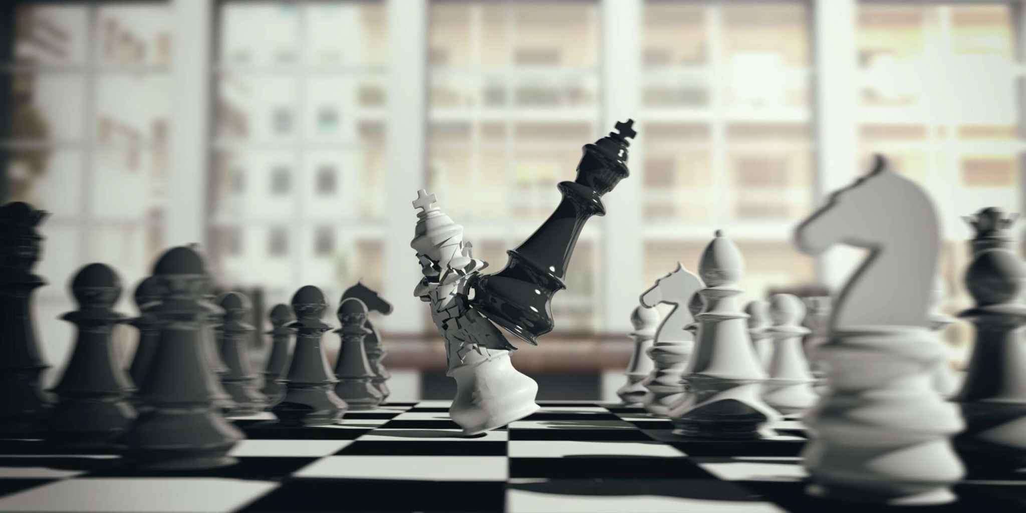 Black chess king toppling a white king, symbolizing a hostile takeover and shift in corporate control