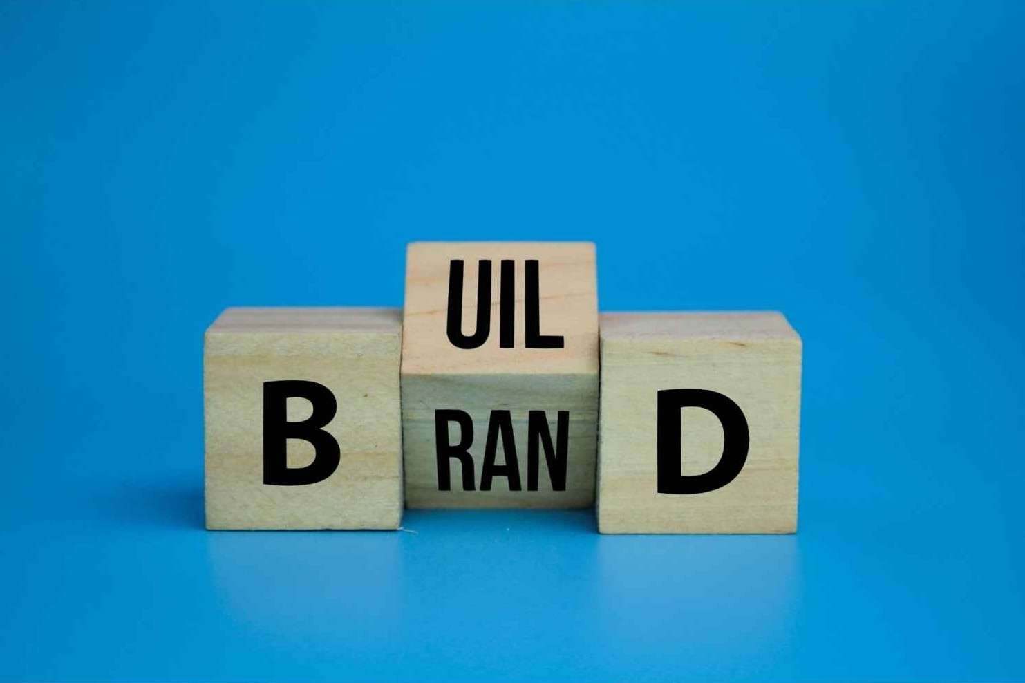 Wooden blocks spelling BUILD YOUR BRAND representing trademark protection for DTC brands in Los Angeles