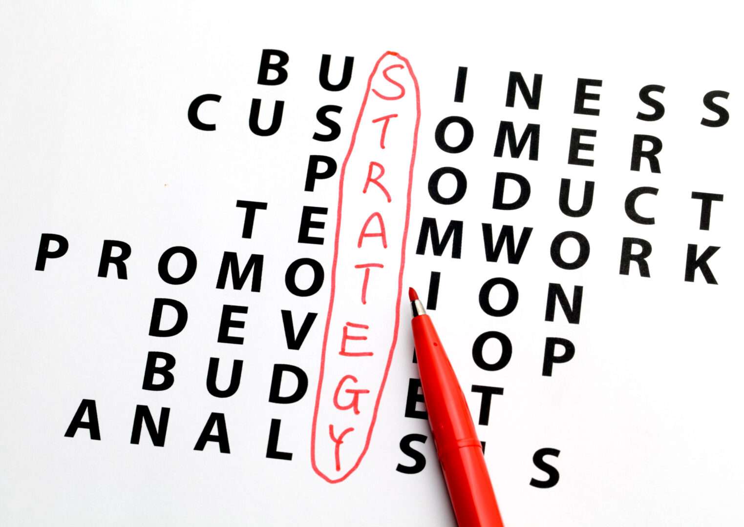 Business strategy crossword puzzle with the word "Strategy" circled in red, representing the importance of a strategic response to a USPTO trademark office action.