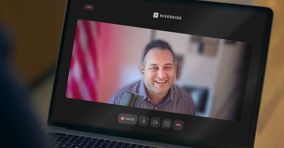 A podcast host smiles into a microphone during a recorded Riverside video session on a laptop screen, representing the Letters of Intent episode offering founders an AI survival guide for protecting their IP.
