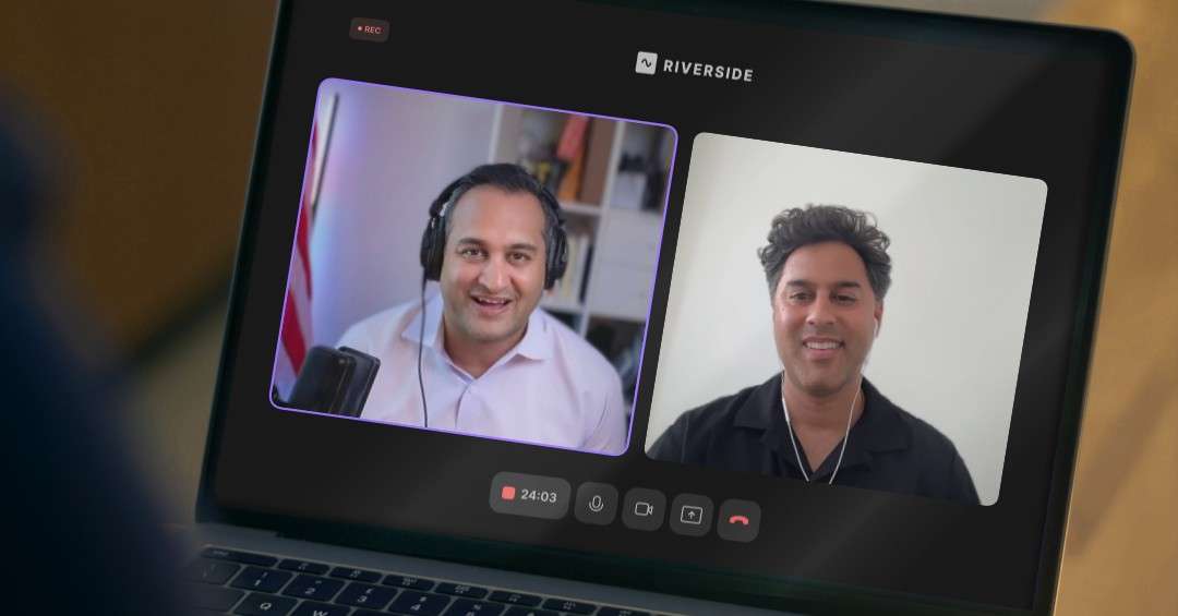 Two podcast hosts smile during a recorded Riverside video session shown on a laptop screen, representing the Letters of Intent episode on the paused Paramount-Warner deal and M&A lessons.