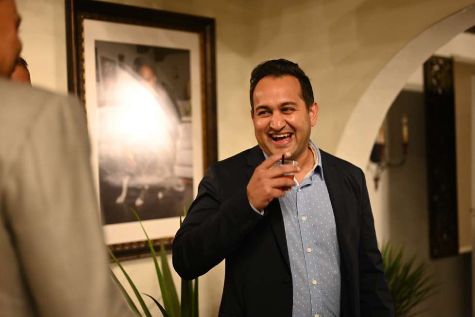 Los Angeles business attorney Pankaj Raval, founder of Carbon Law Group, laughing during a conversation at a networking event