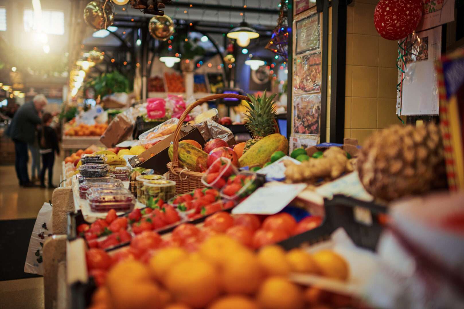 Fresh produce displayed at a covered market stall, representing the kind of owner-operated business that changes hands in a mid-market acquisition